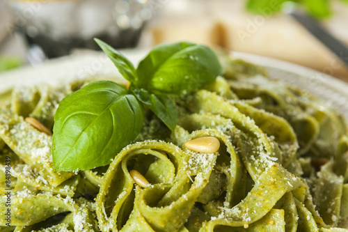 Homemade spinach pasta with pesto and Parmesan cheese