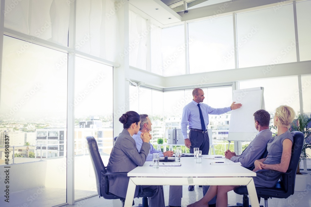 Businessman giving presentation to his colleagues Businessman giving presentation to his colleagues