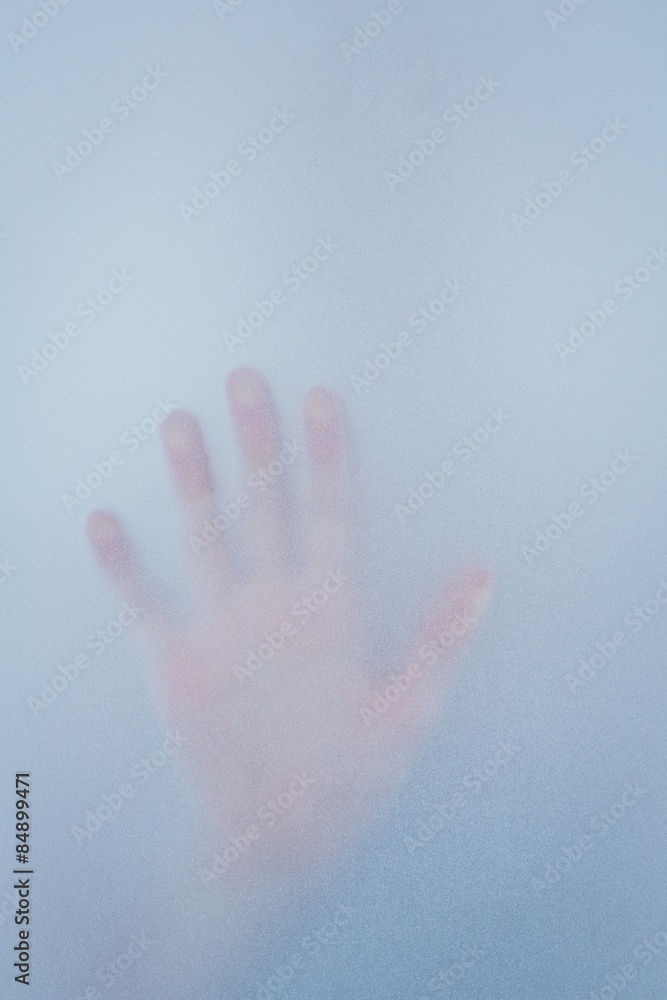 Hand touching frosted glass