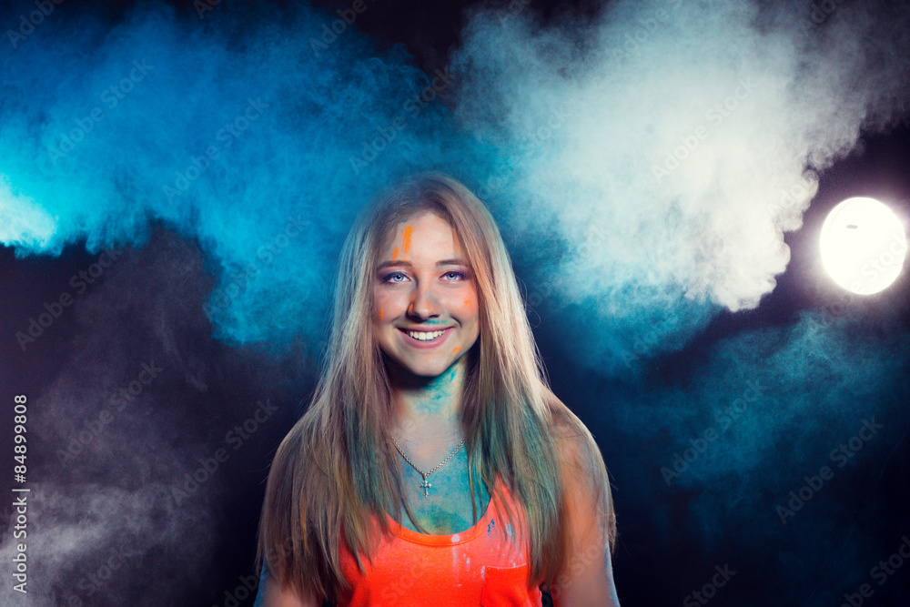 girl with colored powder exploding around her and into the background.