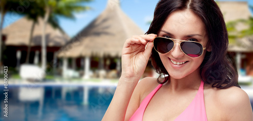 happy woman in sunglasses and swimsuit on beach © Syda Productions