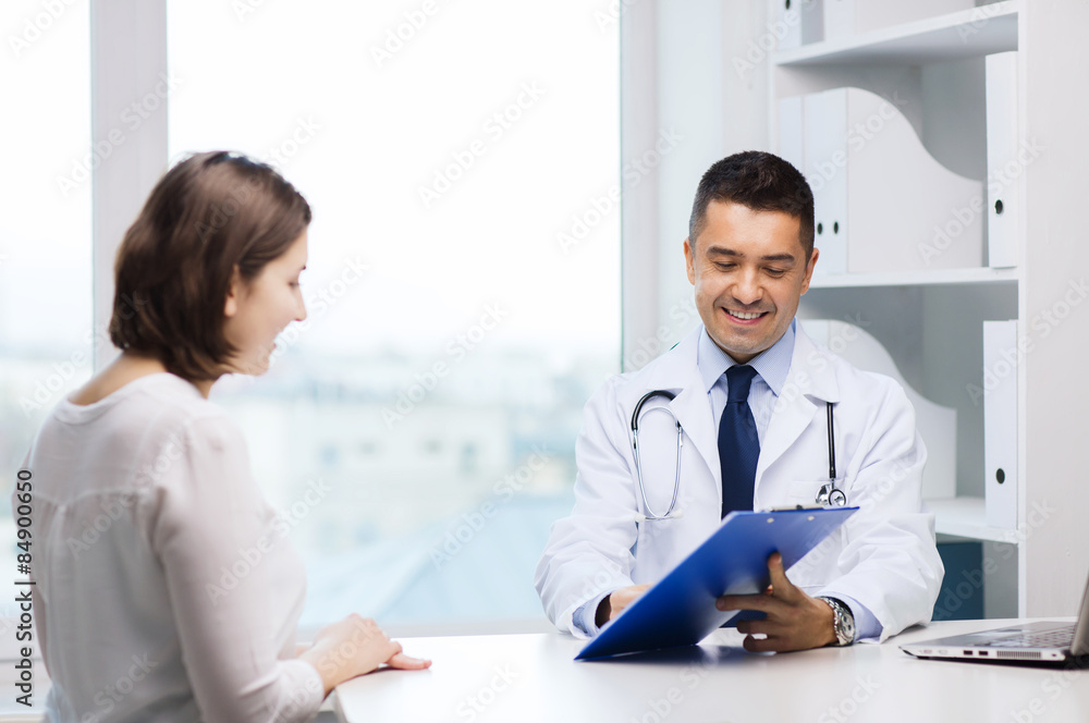 smiling doctor and young woman meeting at hospital