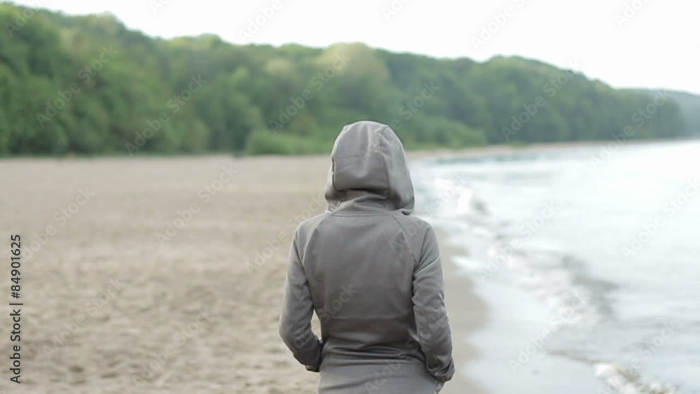 Happy woman walking on the beach, slow motion Happy woman walking on the beach, slow motion