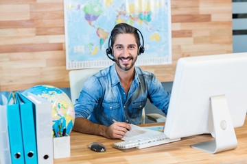Smiling travel agent looking at camera