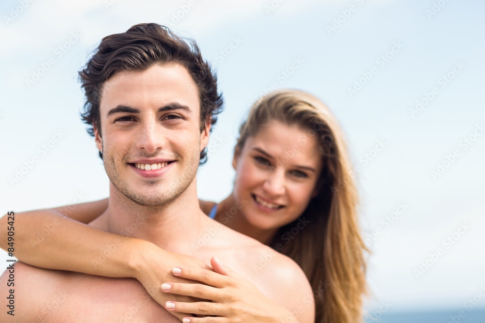 Happy couple in swimsuit looking at camera and embracing Happy couple in swimsuit looking at camera and embracing