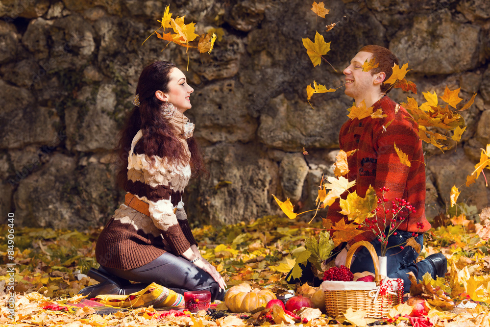 Happy young couple in love meeting on the autumn leaf
