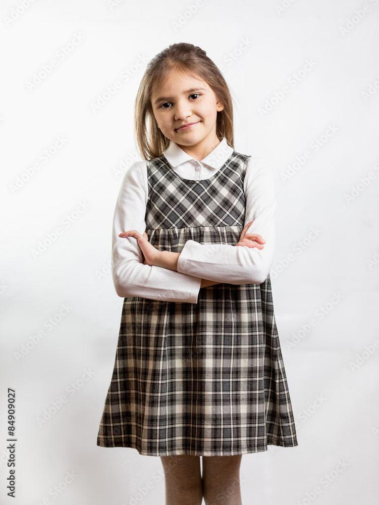 shy schoolgirl in checkered dress against white background shy schoolgirl in checkered dress against white background