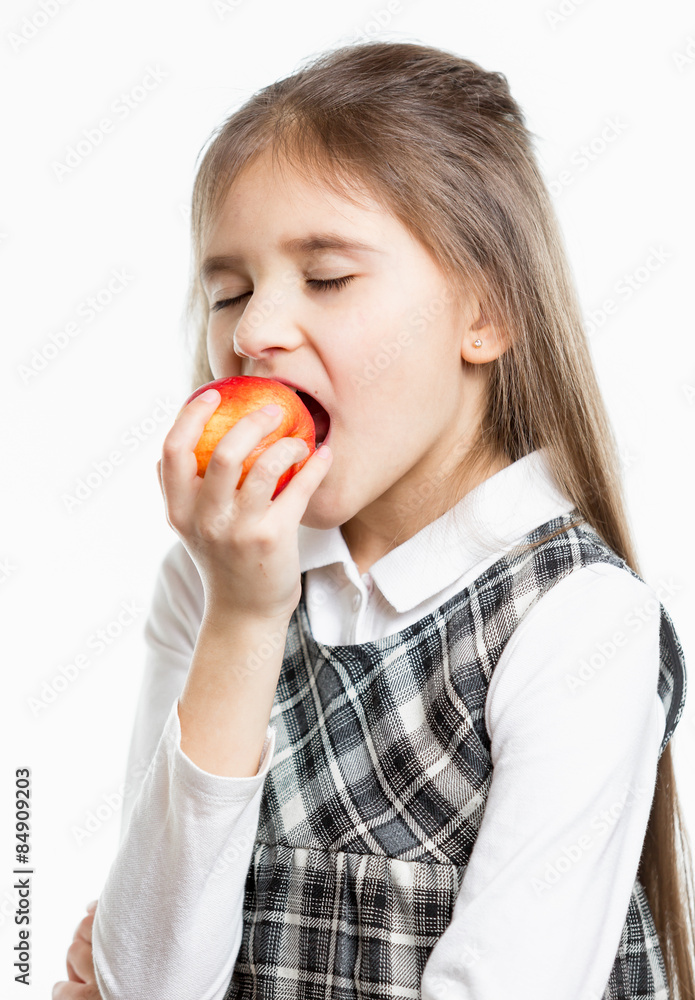 isolated portrait of cute brunette schoolgirl biting red apple isolated portrait of cute brunette schoolgirl biting red apple