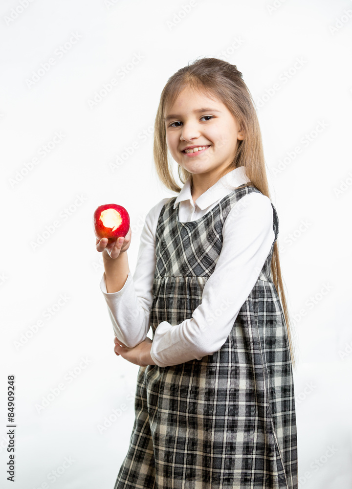 Isolated portrait of happy girl in school uniform holding apple Isolated portrait of happy girl in school uniform holding apple