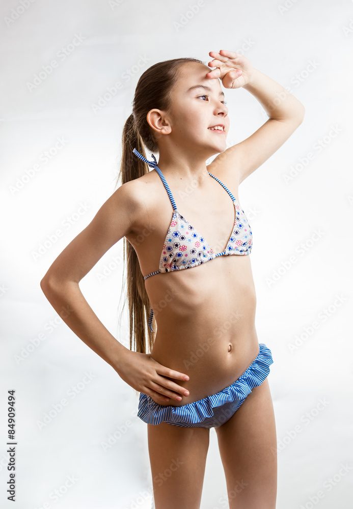 Obraz premium girl in swimsuit posing in studio over white background