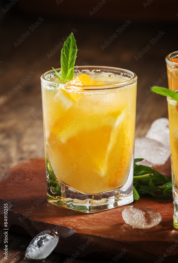 Refreshing cocktail with soda, orange, mint and ice, selective f Refreshing cocktail with soda, orange, mint and ice, selective f