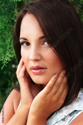 portrait of a beautiful young girl near the tree