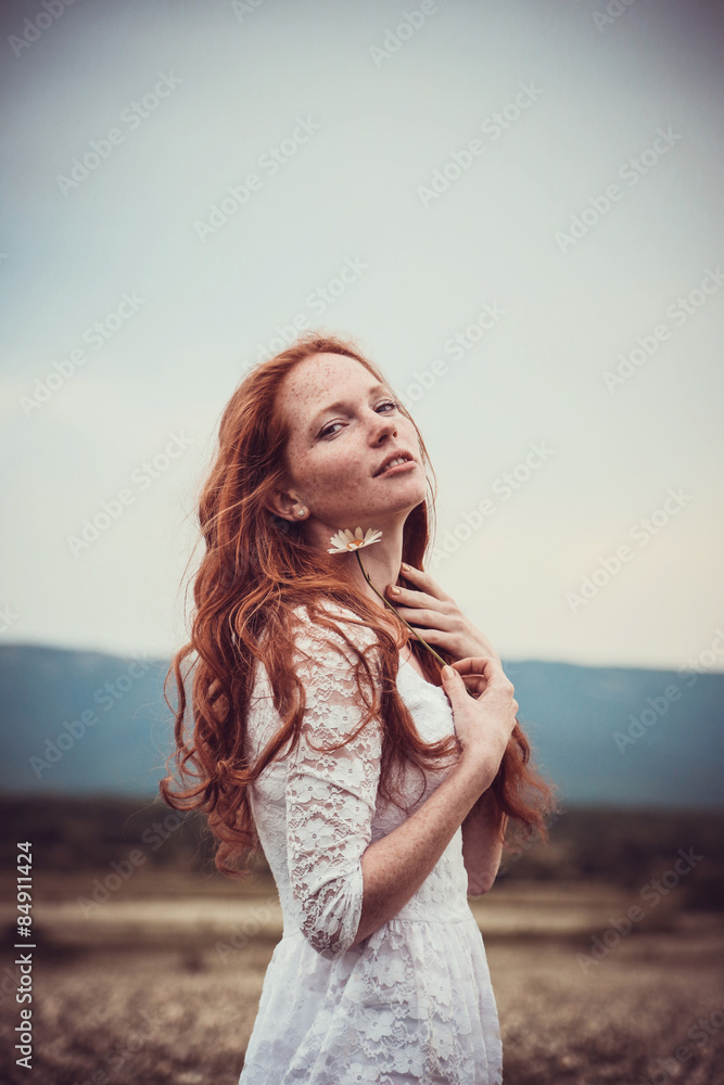 Image of pretty woman lying down on chamomile field, happy femal