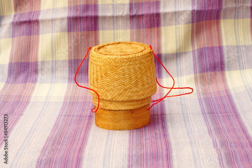 Kratip, thai bamboo sticky rice container on loincloth fabric background