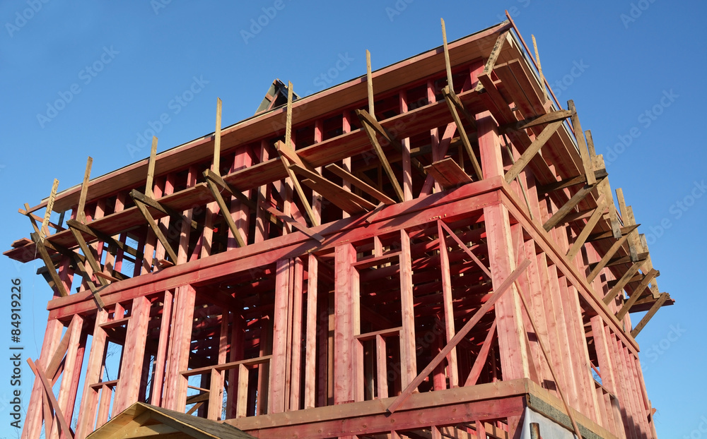 New house- construction concept against the blue sky New house- construction concept against the blue sky