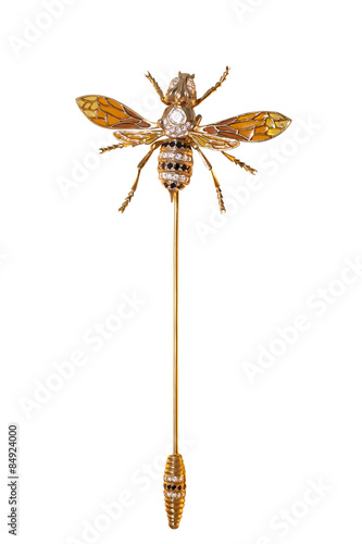 golden brooch with diamonds on a white