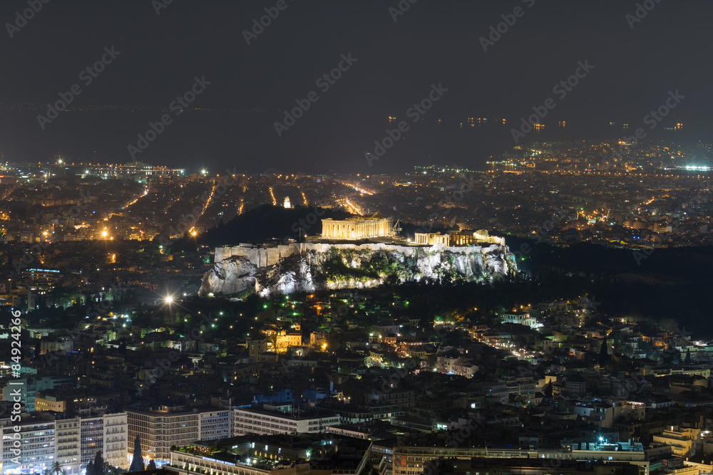 Acropolis in Athens with the city lights as background. Night view.
