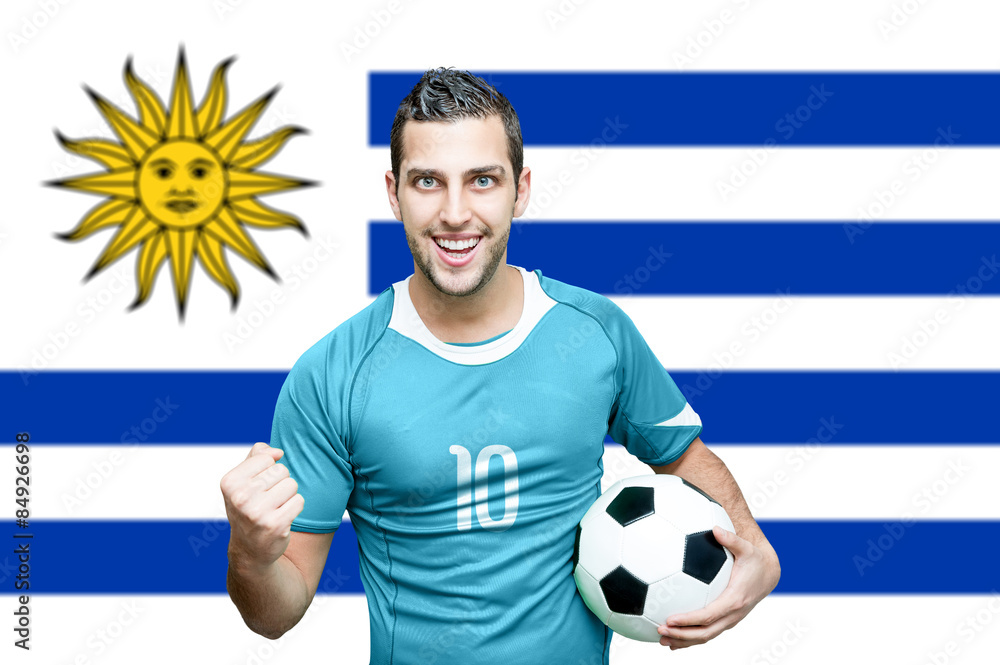 Uruguayan fan celebrates on Uruguay flag background StockFoto Adobe