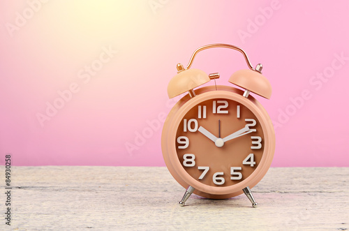 brown clock on wood background