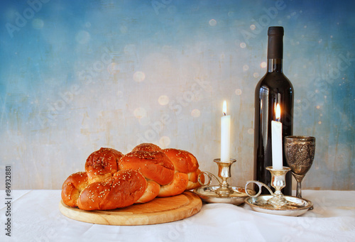 shabbat image. challah bread, shabbat wine and candels
