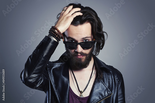 young bearded man in leather jacket.Hipster in sunglasses
