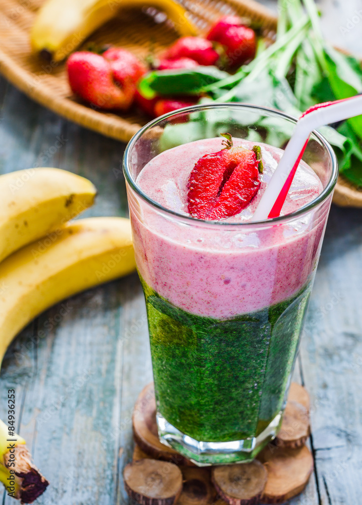 double smoothies, green with spinach, kiwi and banana with straw double smoothies, green with spinach, kiwi and banana with straw