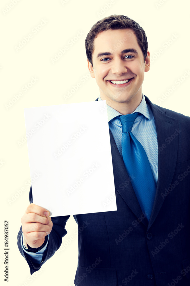 Happy smiling businessman showing blank signboard Happy smiling businessman showing blank signboard