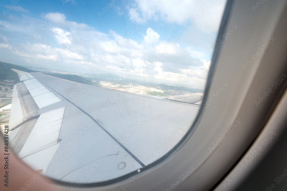Clouds and sky as seen through window of an aircraft Clouds and sky as seen through window of an aircraft