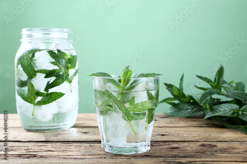 bevanda ghiacciata acqua e foglie di menta sfondo verde