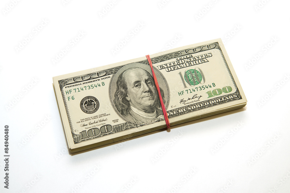 Bundle of US dollars banknotes on a white background Bundle of US dollars banknotes on a white background