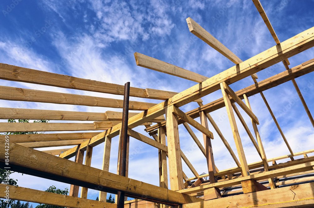 Installation of wooden beams at construction of the frame house Installation of wooden beams at construction of the frame house