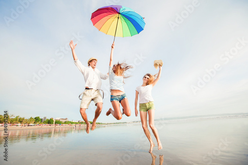Group of happy young people having fun on the beach