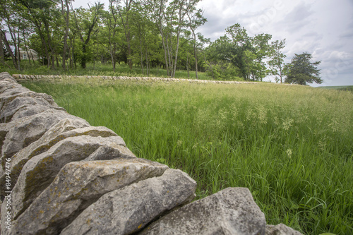 old limestone fence and grassy meadow, Tallgrass Prairie National Preserve, Kansas
