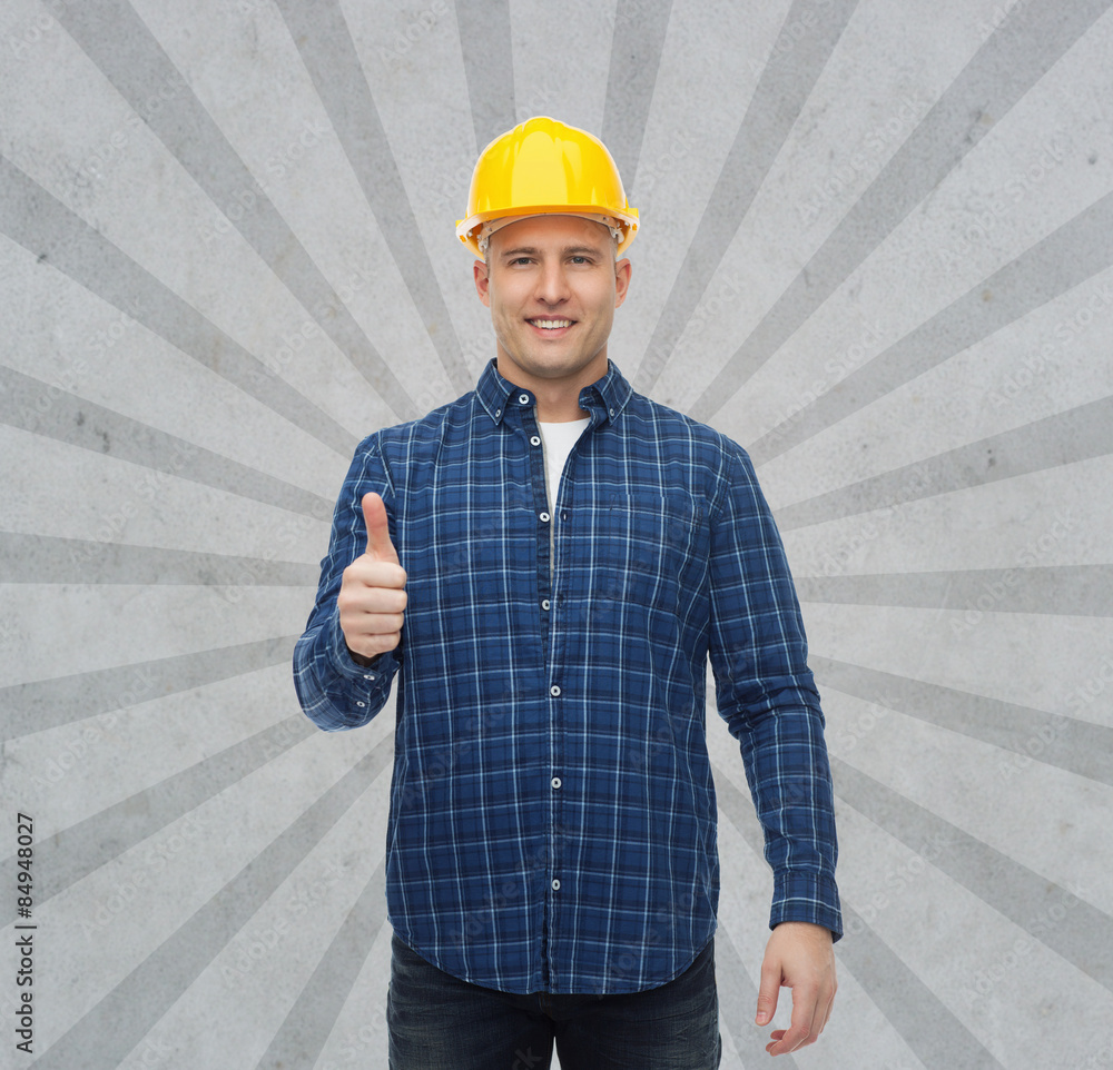 smiling male builder in helmet showing thumbs up smiling male builder in helmet showing thumbs up