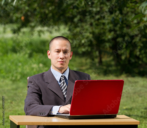 man with laptop working outdoors