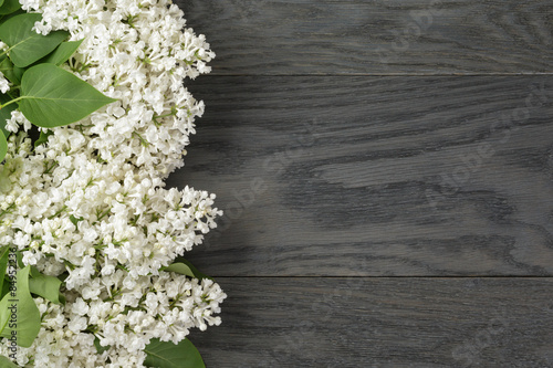 white lilac flower on old oak table top view with copy space