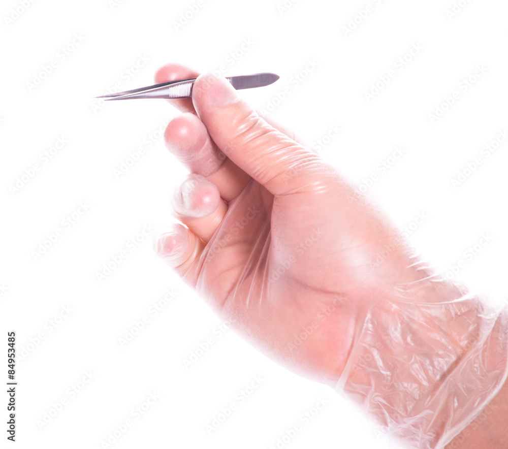hand in rubber glove holding tweezers hand in rubber glove holding tweezers