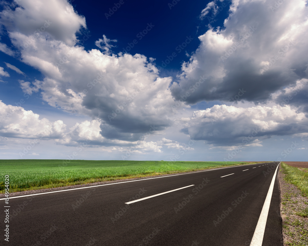 Driving on an empty asphalt road at sunny day