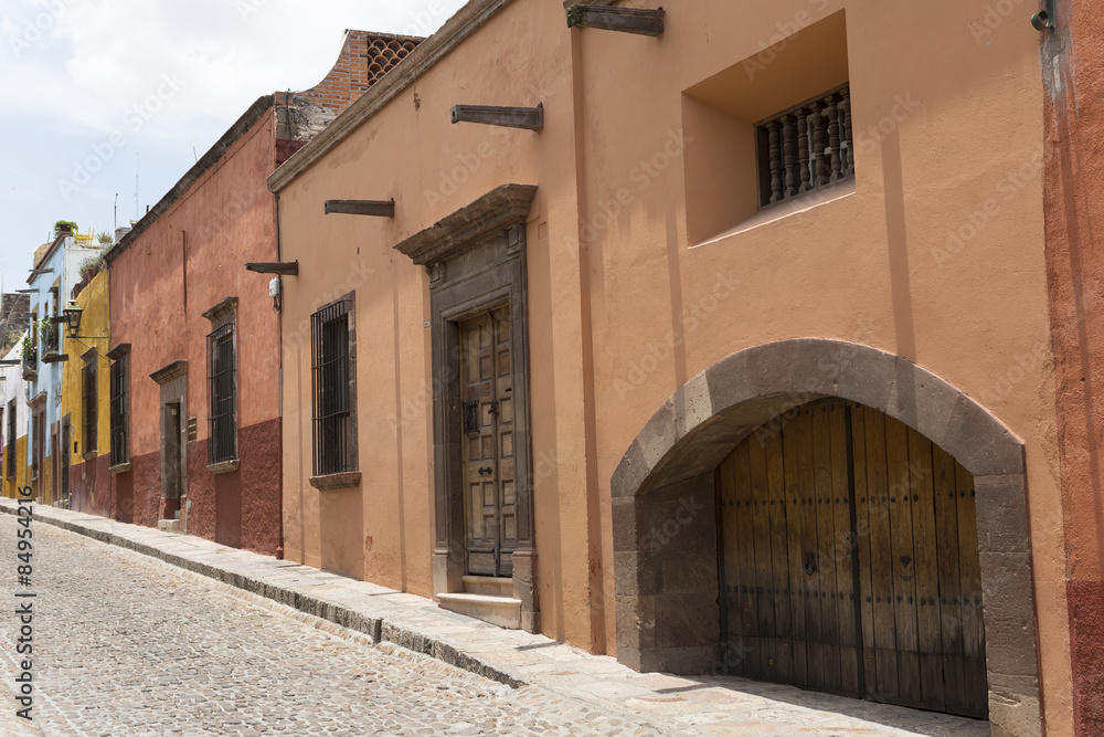 cobblestone street with colonial houses in Mexico