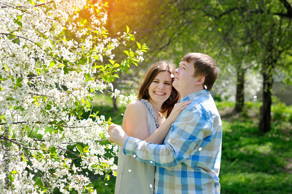 young couple in love walking in the blossoming spring garden young couple in love walking in the blossoming spring garden
