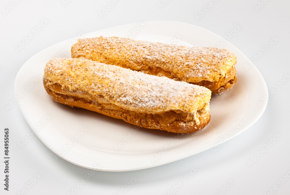 two eclairs on white dish