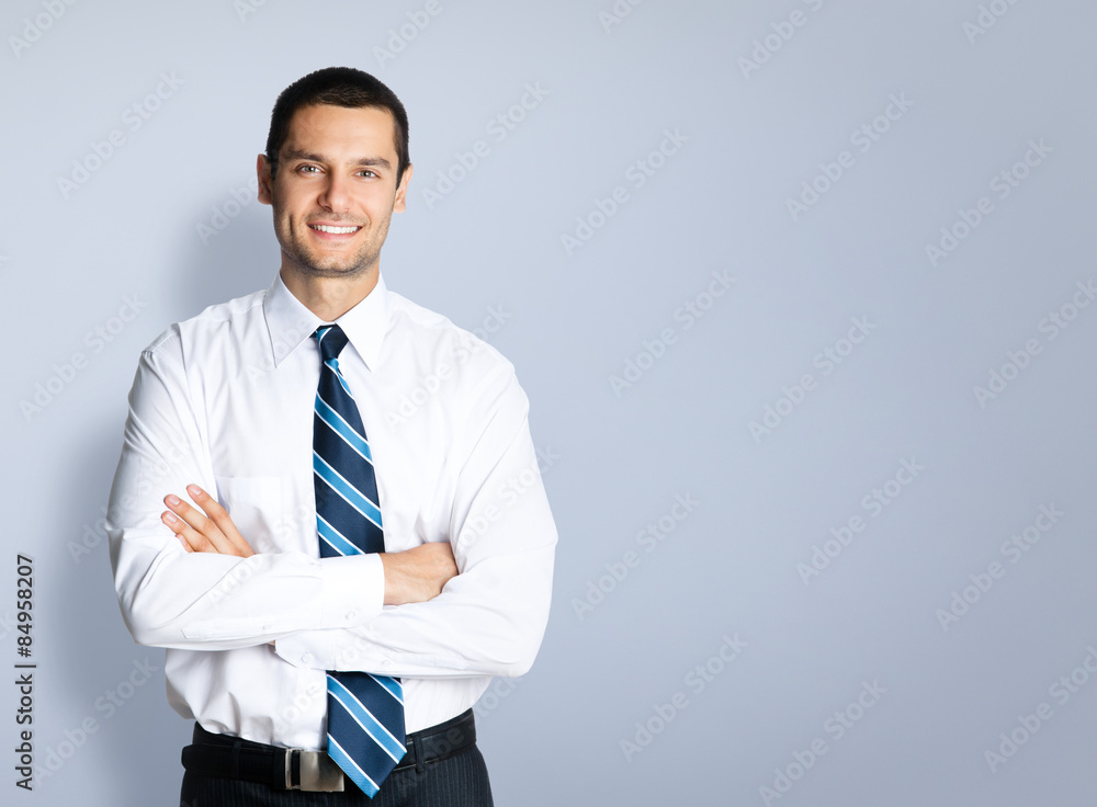 Happy smiling businessman, over grey Happy smiling businessman, over grey