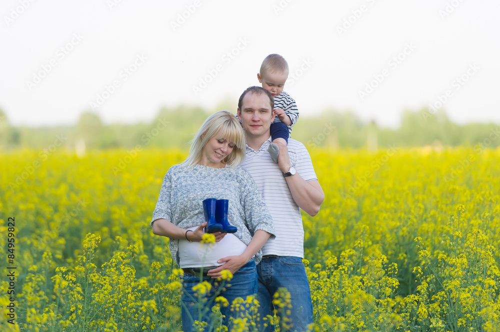 family from three people on a rape field family from three people on a rape field