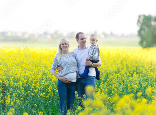 family from three people on a rape field