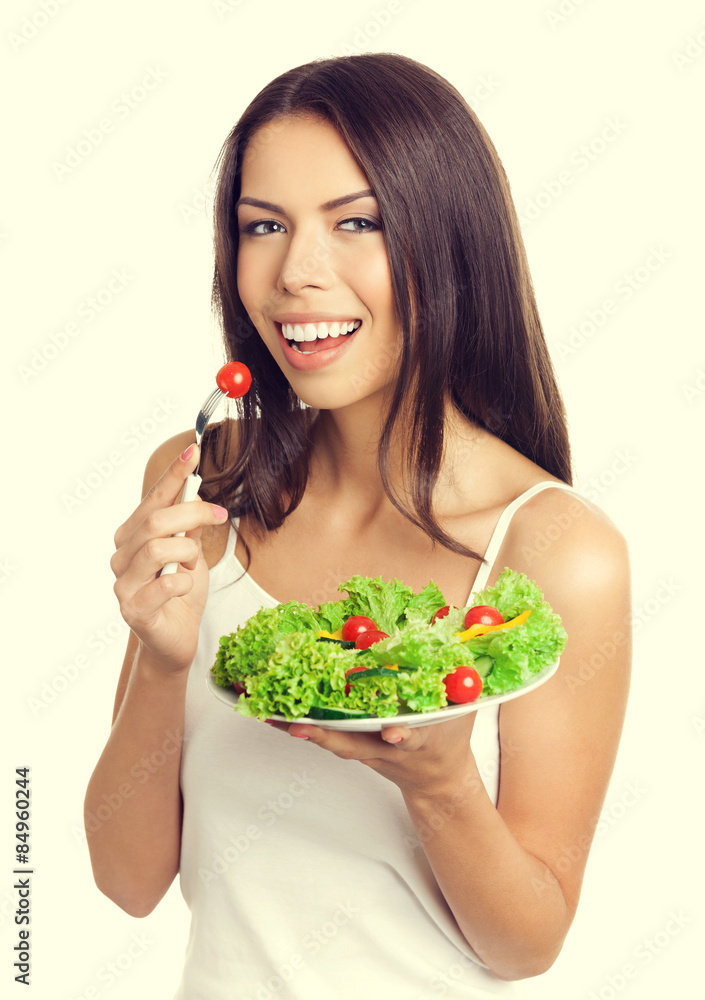 Young woman eating vegetarian salad with cherry tomatoes Young woman eating vegetarian salad with cherry tomatoes