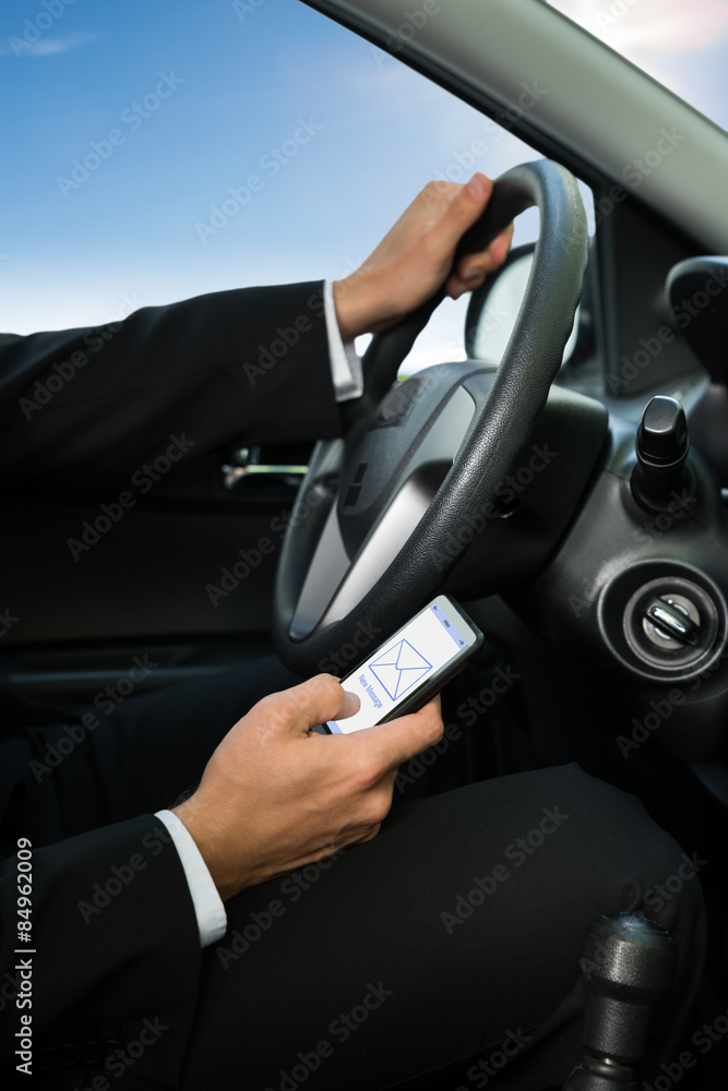 Man Texting While Driving His Car