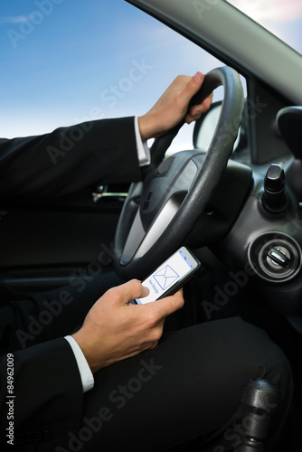 Man Texting While Driving His Car © Andrey Popov