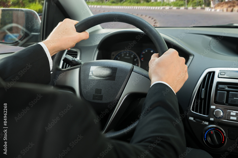 Close-up Of A Driver's Hand On Steering Wheel