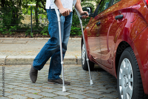 Fotografia, Obraz Disabled Man With Crutches Walking Near Care