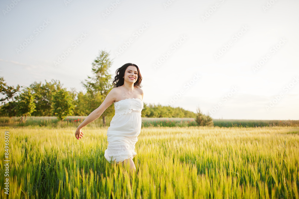 pregnant gorgeous brunette woman on the field with wheat and pop pregnant gorgeous brunette woman on the field with wheat and pop
